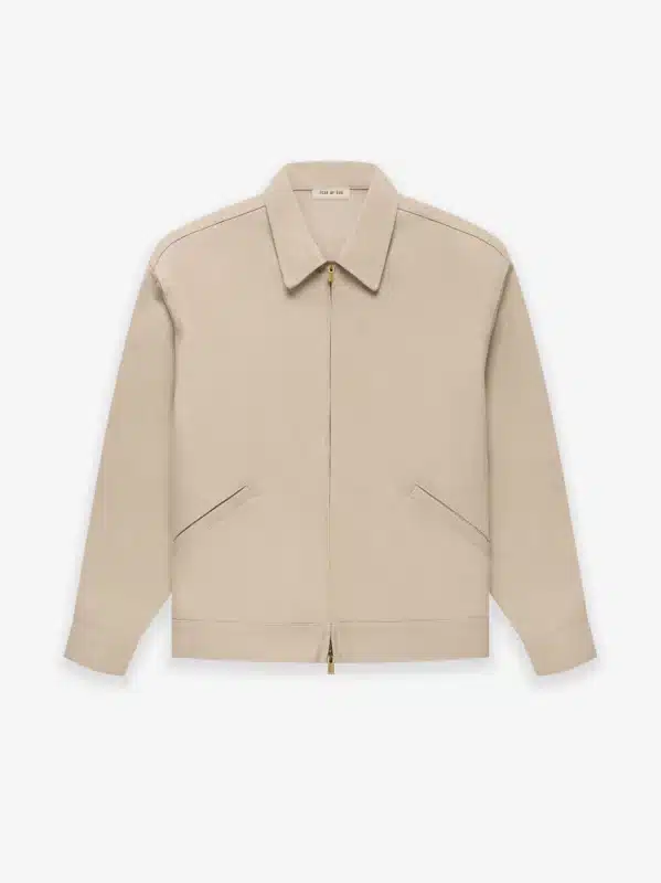 A Fear of God Taupe Zip Denim Jacket 'Dusty Beige', featuring long sleeves, a pointed collar, and two diagonal front pockets, displayed on a plain white background.