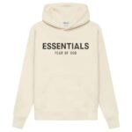 The Fear of God Essentials Oversized Hoodie 'Butter-Cream' showcases a cream-colored design with bold black ESSENTIALS text and FEAR OF GOD subtly printed beneath it. It includes a front pocket and a drawstring hood.