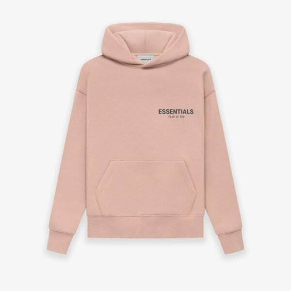 A 'Pink' hoodie from Fear of God Essentials features a front pocket and hood. The chest showcases the text ESSENTIALS Fear of God in black print, set against a plain white background.