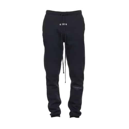 FOG Essentials x SSENSE Sweatpants in black, featuring a drawstring waist and small white lettering on the waistband area. These sweatpants have a slim fit and are displayed against a plain white background.