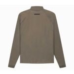 Back view of the Fear of God Essentials Half Zip Track Jacket featuring a long-sleeve, olive-green design with a high collar, prominently displaying its label near the top center of the back and elastic cuffs.